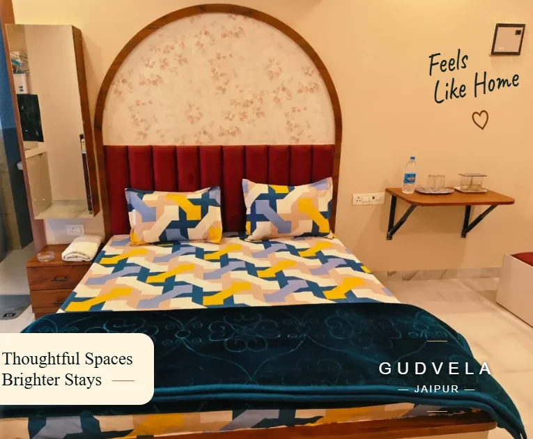 GUDVELA bedroom with an arched headboard, patterned cushions and a teal bedcover